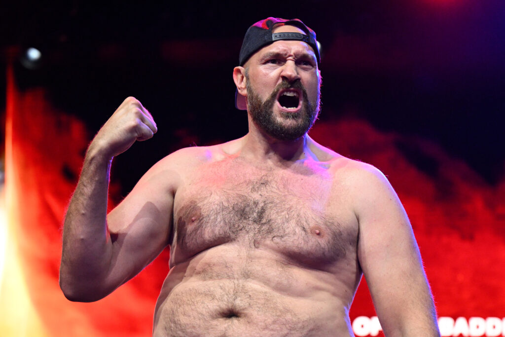 Tyson Fury poses on the scale during the ceremonial weigh-in for his fight with Francis Ngannou