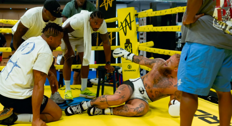 Jake Paul being attended to by his team after breaking his ankle