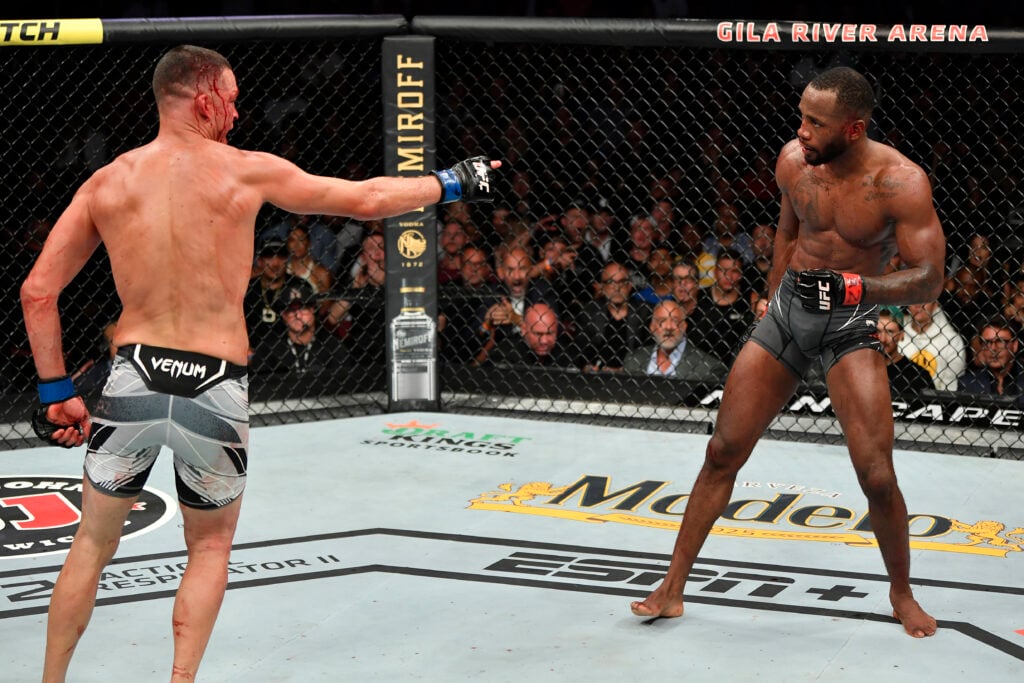 Nate Diaz points at Leon Edwards after hurting him with a punch during their UFC 263 fight.