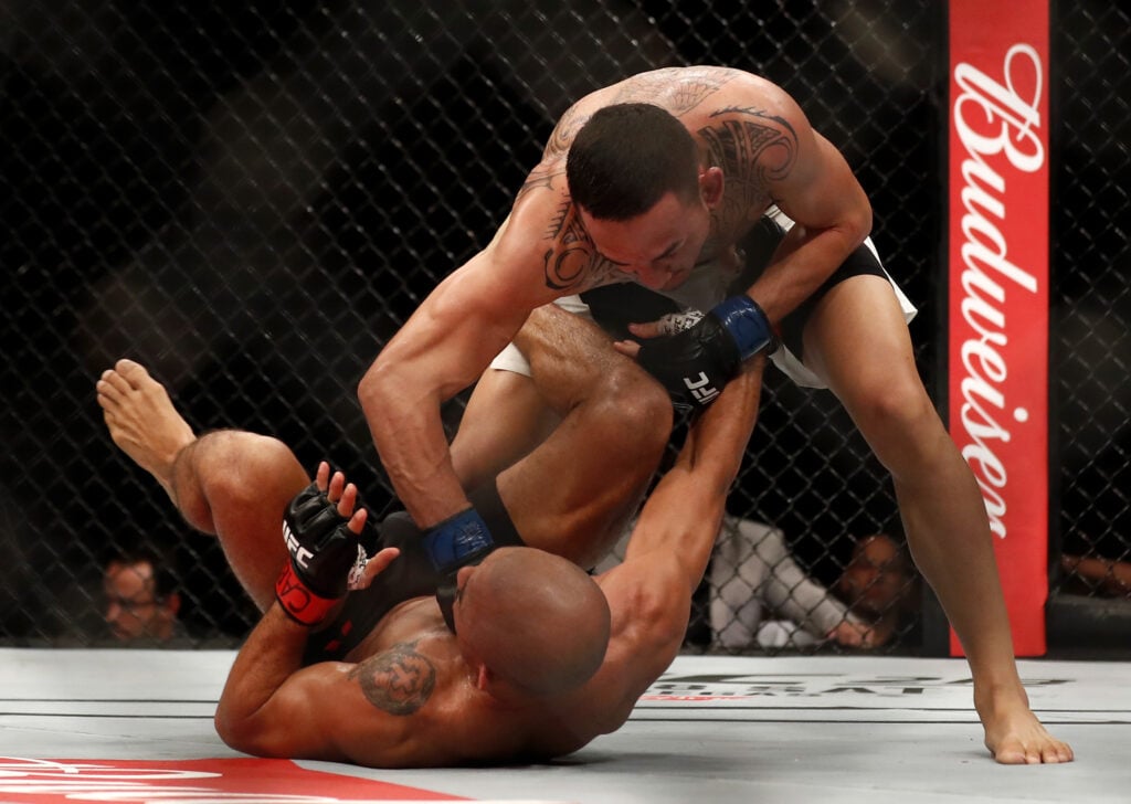 Max Holloway punches Jose Aldo at UFC 212