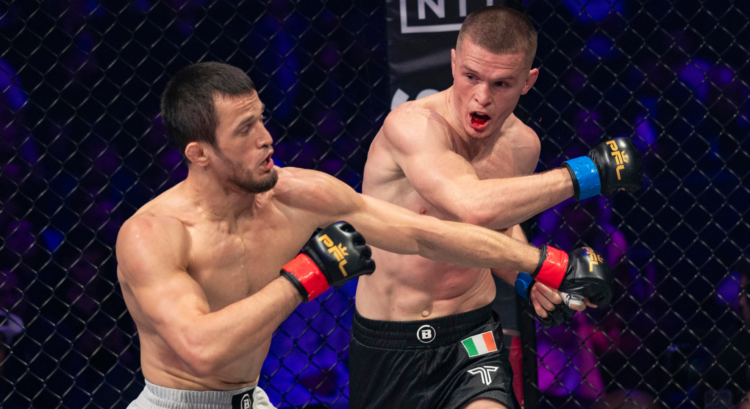 Paul Hughes punches Usman Nurmagomedov during their Bellator title fight