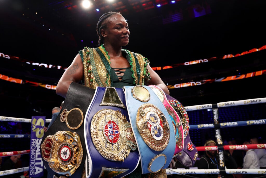 Image of Claressa Shields holding four boxing world titles