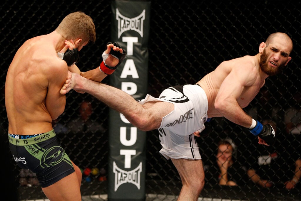 Adlan Amagov spinning back kicks an opponent during a UFC fight