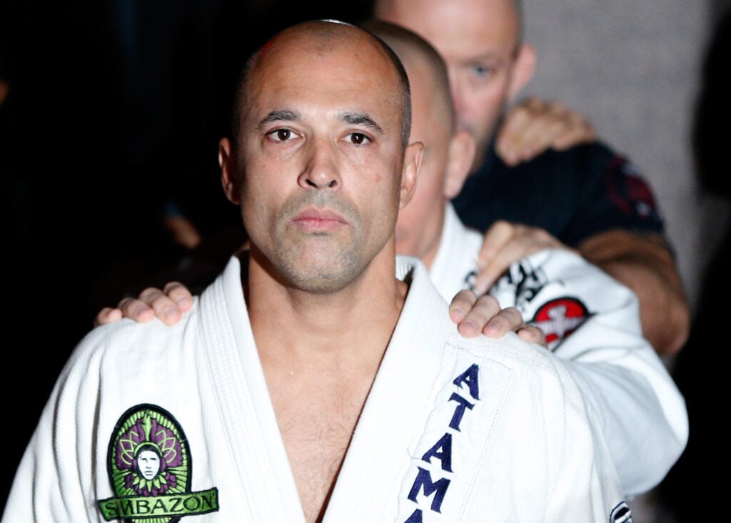 Royce Gracie leads Georges St-Pierre onto the stage at UFC 167 open workouts