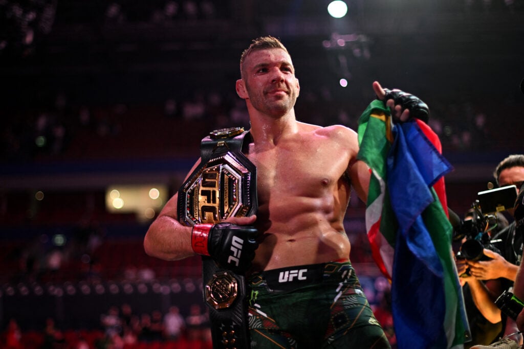 Dricus Du Plessis with the UFC middleweight title belt and the Suth African flag