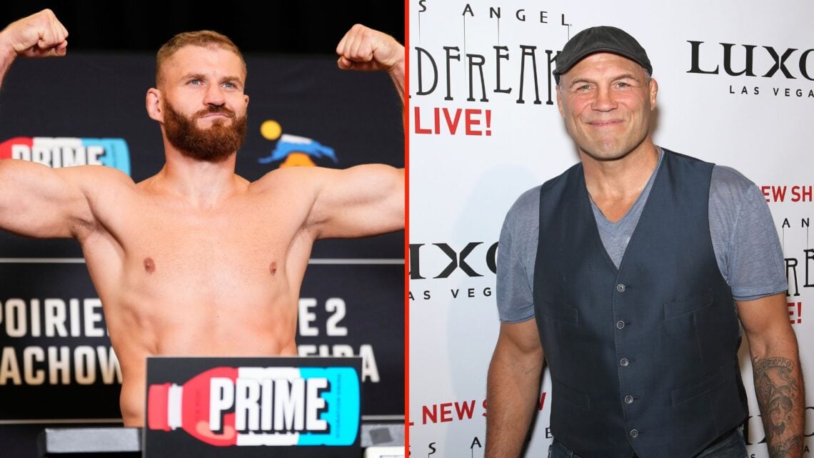 Jan Blachowicz of Poland poses on the scale during the UFC 291 official weigh-in, and Former mixed martial artist and actor Randy Couture attends t...