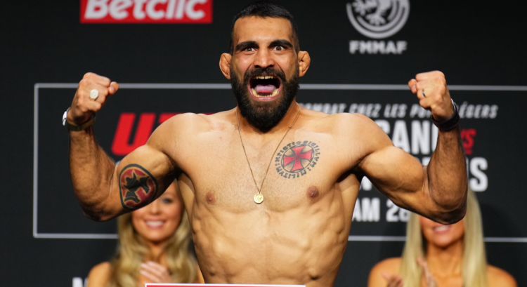 Benoit Saint-Denis poses on the scale at the UFC Paris ceremonial weigh-in.