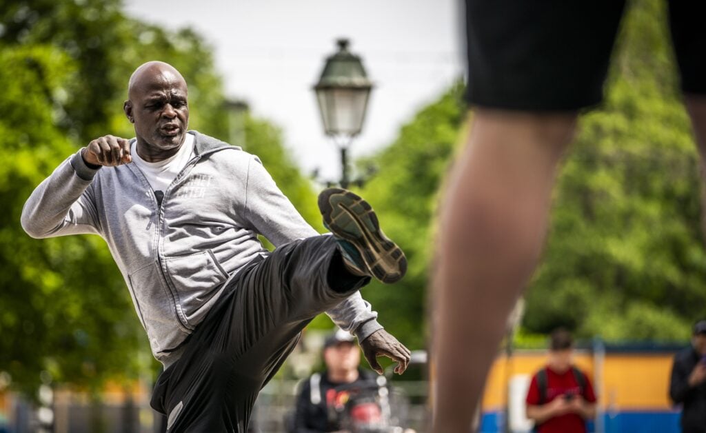 Ernesto Hoost demonstrates a kick during a protest in The Netherlands