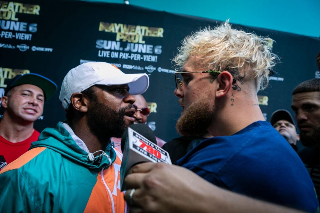 Jake Paul confronts Floyd Mayweather Jr. during a pre-fight promotional event.