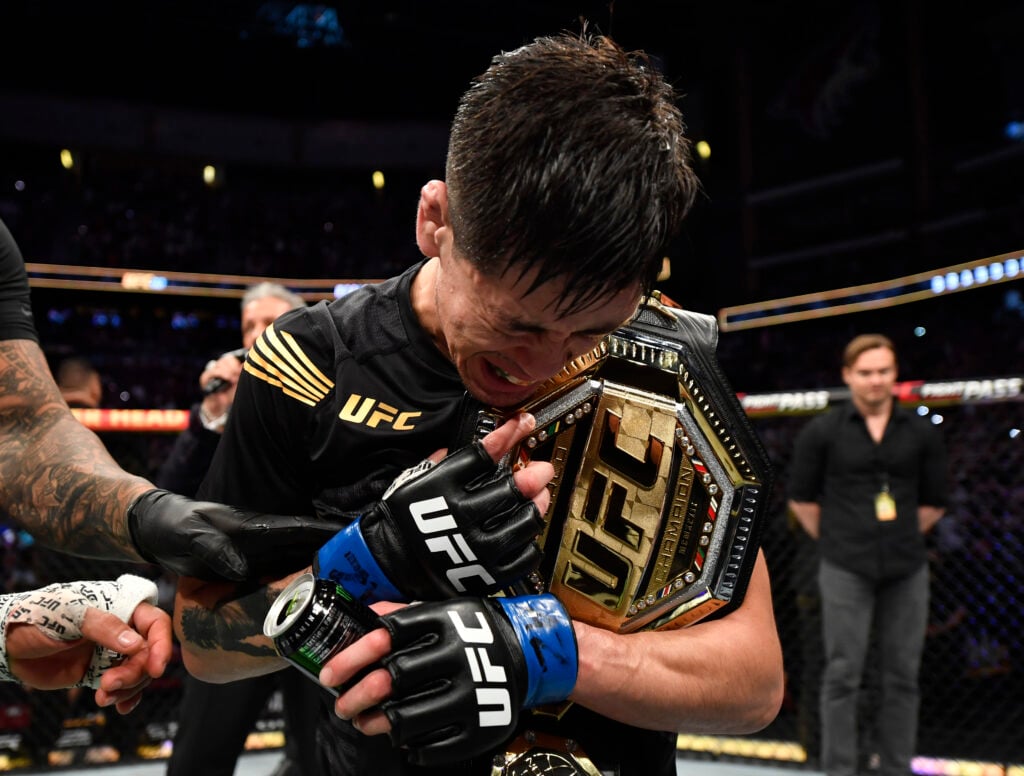 Brandon Moreno celebrates with the UFC title at UFC 263