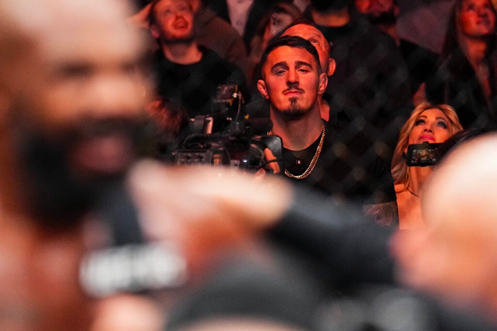 Tom Aspinall watching on as Jon Jones does his post-fight interview at UFC 309