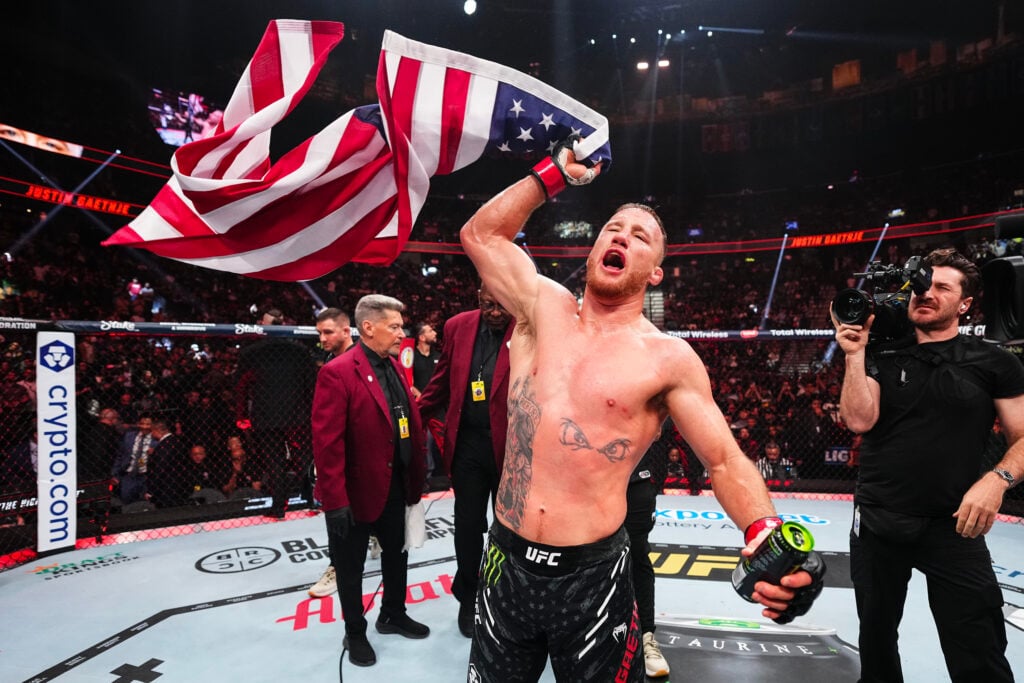 Justin Gaethje celebrates with an American flag after UFC 313.