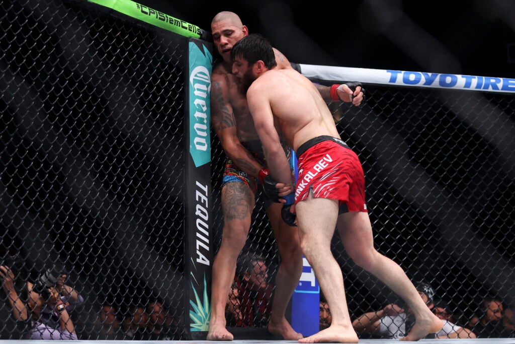 Alex Pereira and Magomed Ankalaev grapple during UFC 313 fight.