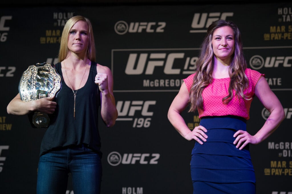 Holly Holm and Miesha Tate pose at the UFC 196 press conference