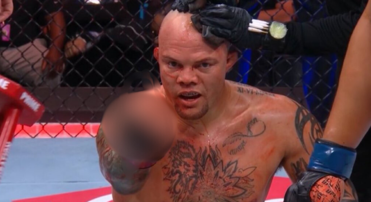 Anthony Smith making a crude gesture (censored) at a fan