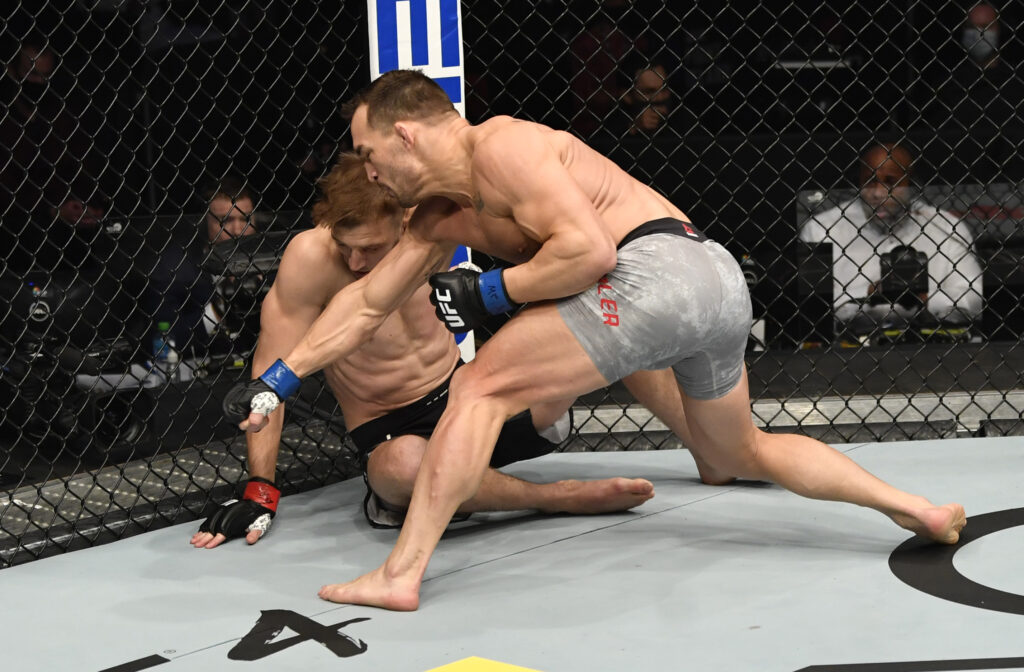 Michael Chandler punches Dan Hooker at UFC 257
