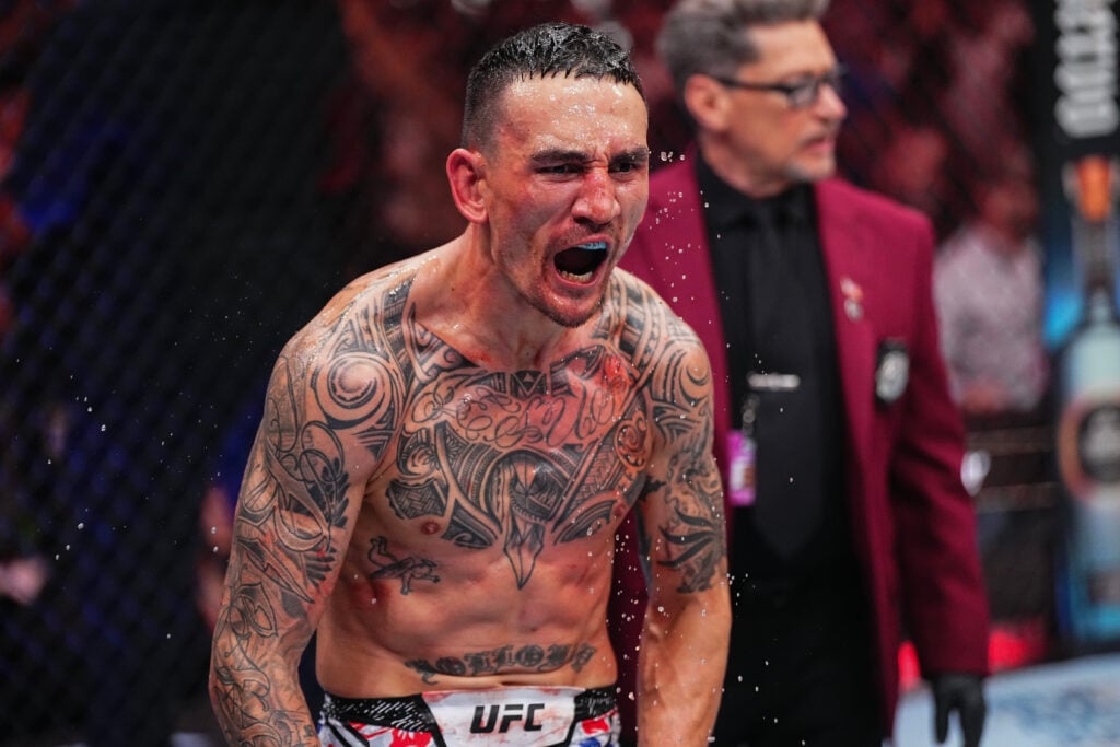 Max Holloway celebrates in the octagon after a knockout win over Justin Gaethje at UFC 300