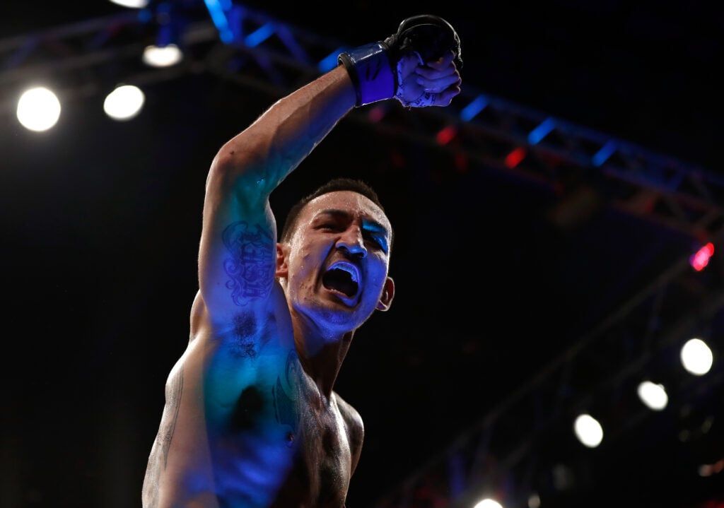 Max Holloway celebrates after beating Jose Aldo