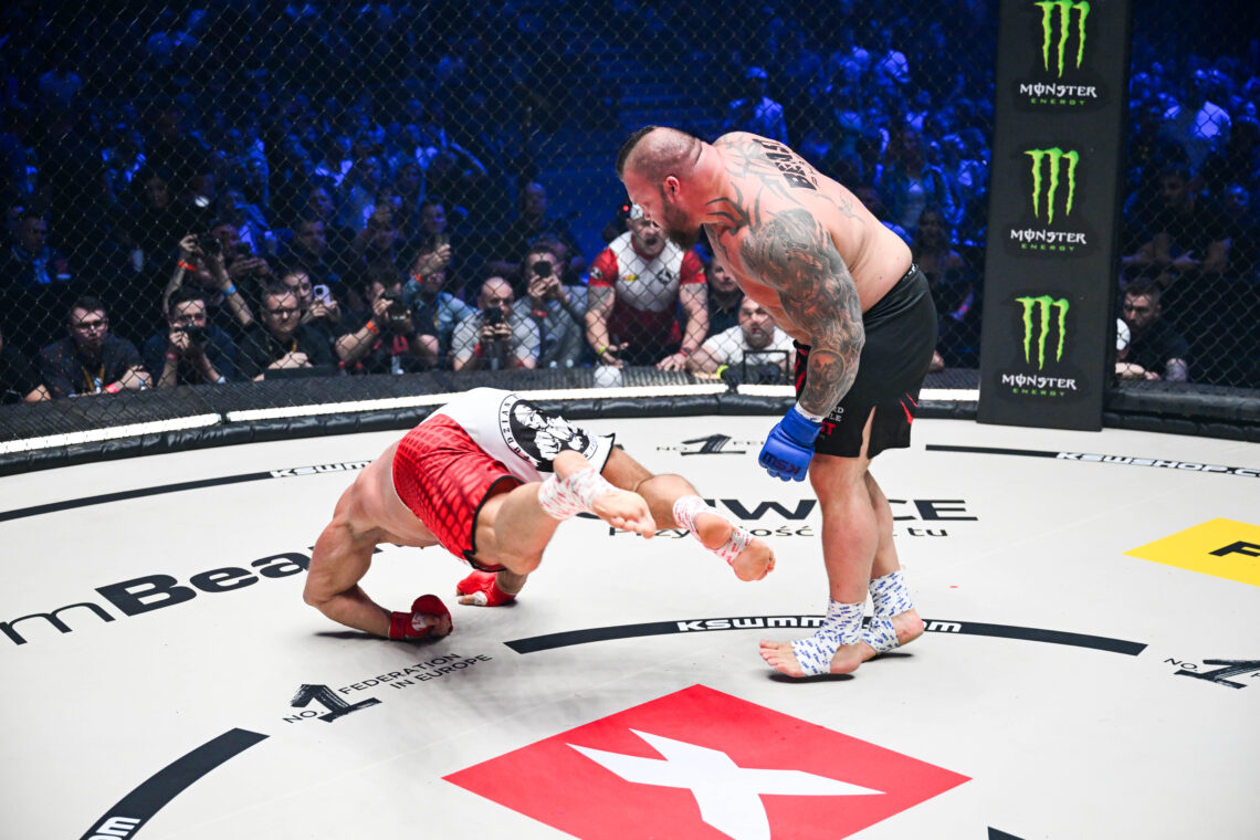 Eddie Hall stands over Mariusz Pudzianowski during their KSW fight
