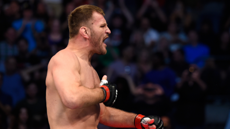 Image of Stipe Miocic celebrating his TKO victory over Junior Dos Santos at UFC 211