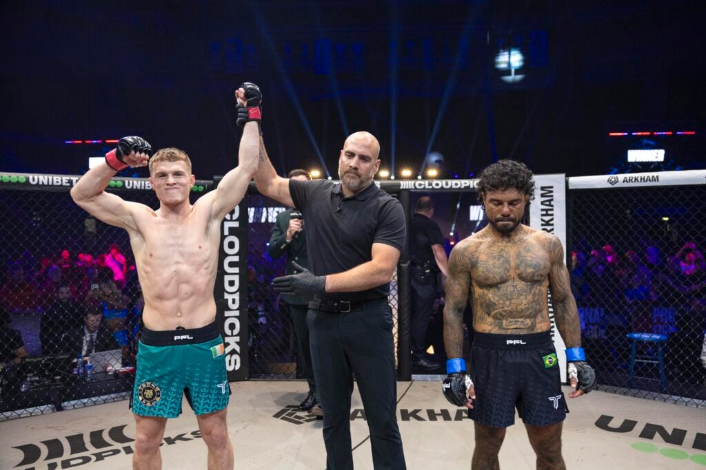 Paul Hughes gets his hand raised by the referee after beating Bruno Miranda at PFL Belfast