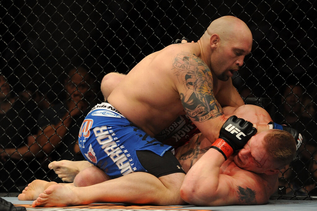 Shane Carwin elbows Brock Lesnar during their UFC 116 fight