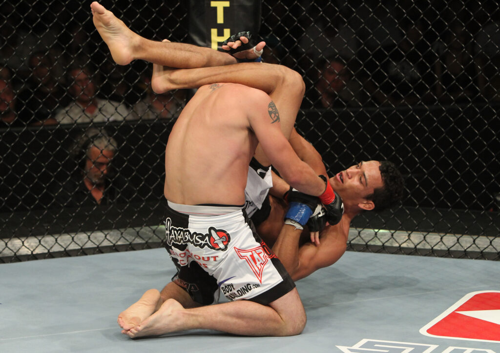 Charles Oliveira submits Darren Elkins with an armbar in his UFC debut