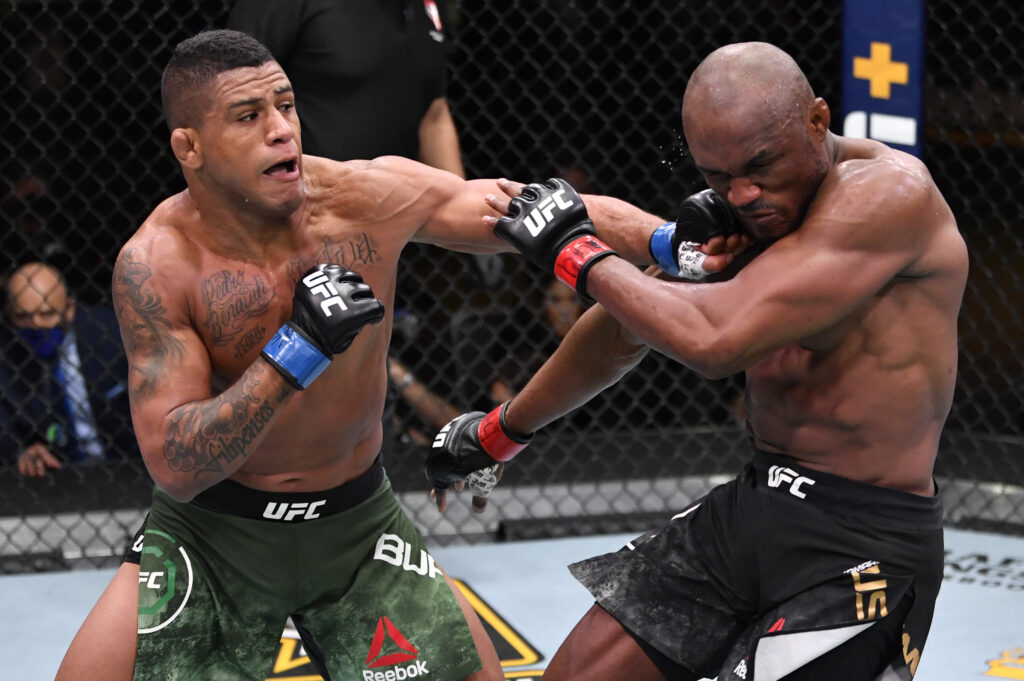 Gilbert Burns of Brazil punches Kamaru Usman of Nigeria in their UFC welterweight championship fight during the UFC 258 event at UFC APEX on February 13, 2021.