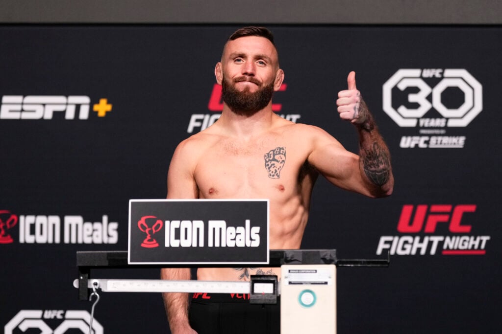 Tim Elliott poses on the scales ahead of his fight with Su Mudaerji