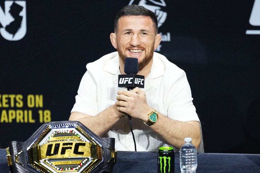Merab Dvalishvili sat with a smile at the UFC 316 press conference