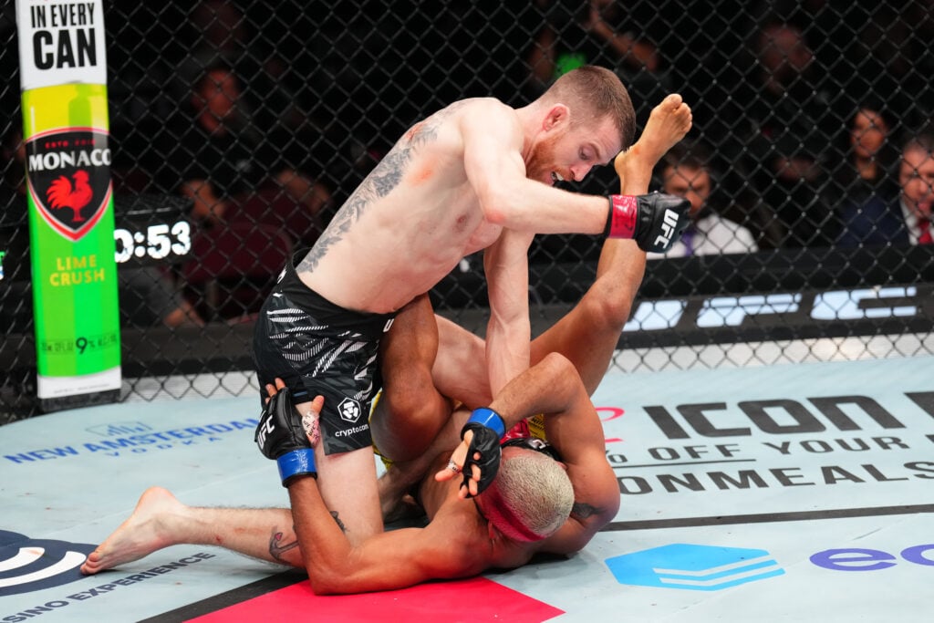 Cory Sandhagen punches Deiveson Figueiredo during a scramble at UFC Des Moines
