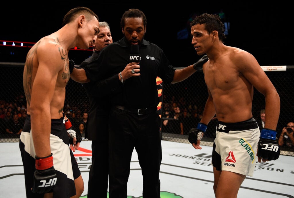 Max Holloway and Charles Oliveira get final instructions from Herb Dean before UFC Fight Night fight