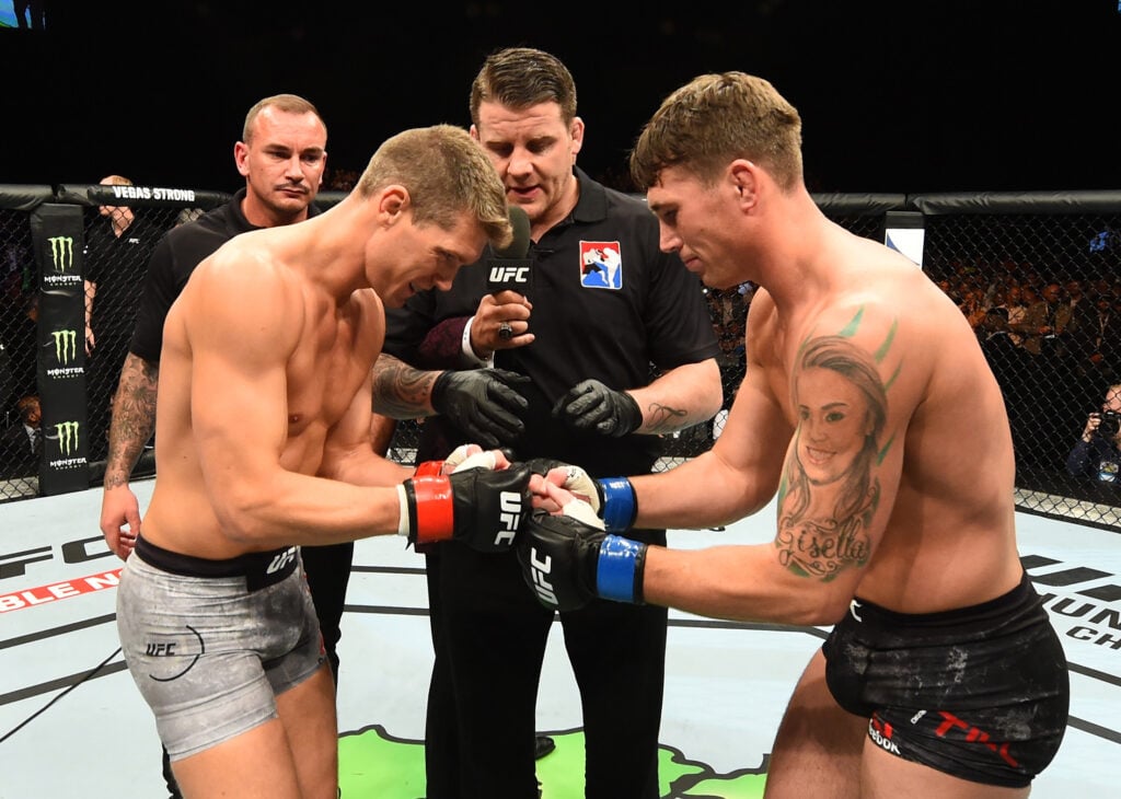 Stephen Thompson and opponent Darren Till touch gloves in the Octagon at UFC Liverpool