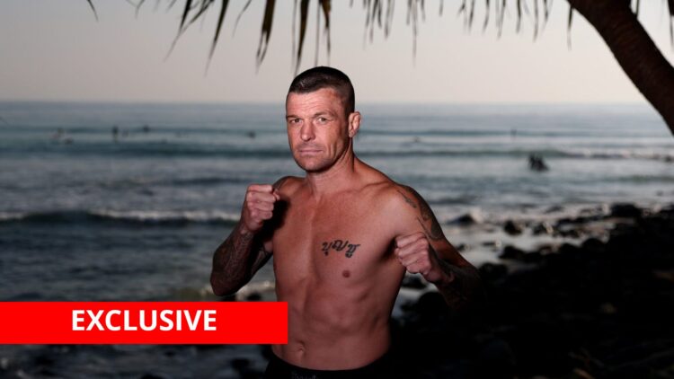 John Wayne Parr poses by the sea with exclusive banner