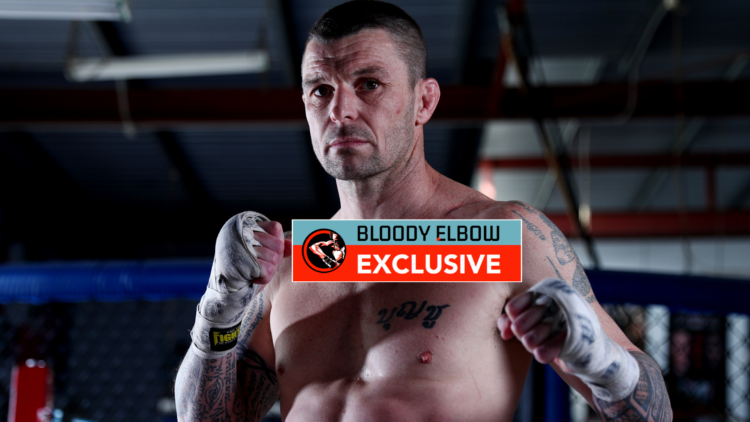 John Wayne Parr at a photoshoot with exclusive banner