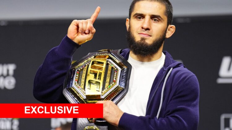 Islam Makhachev on stage at the UFC 311 press conference with an exclusive banner