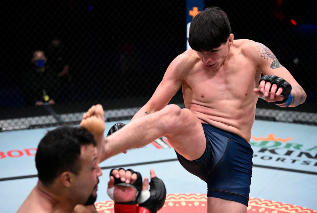 Ignacio Bahamondes kicks Edson Gomez during their Contender Series fight