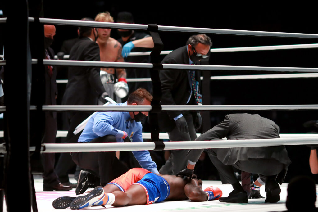 Nate Robinson receives medical attention after being knocked out by Jake Paul in their Triller fight.