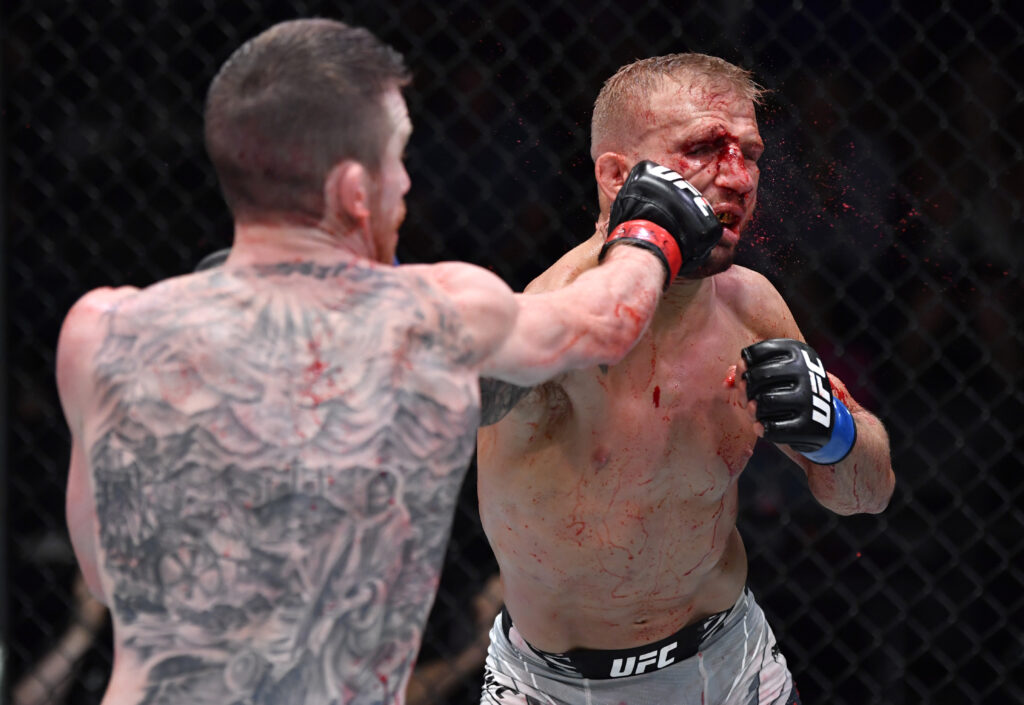 Cory Sandhagen punches TJ Dillashaw during their bantamweight fight at the UFC Apex