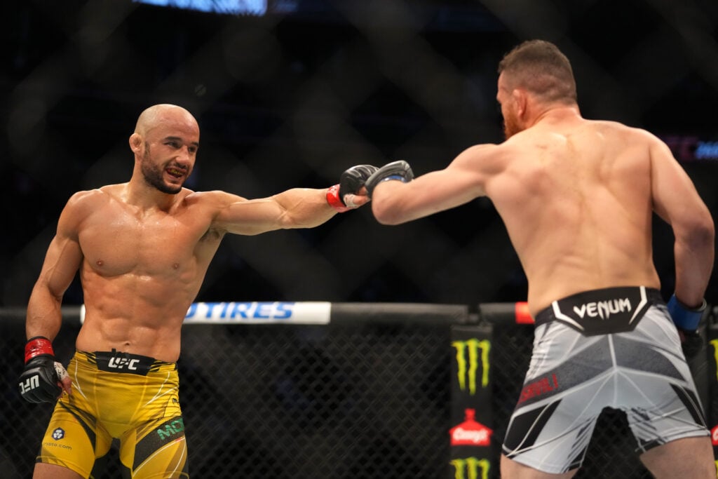 Marlon Moraes and Merab Dvalishvili touch gloves during their fight at UFC 266