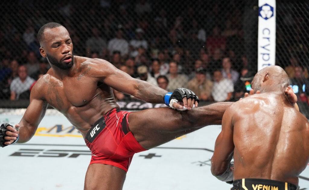 Leon Edwards head kicks Kamaru Usman in Round 5 at UFC 278