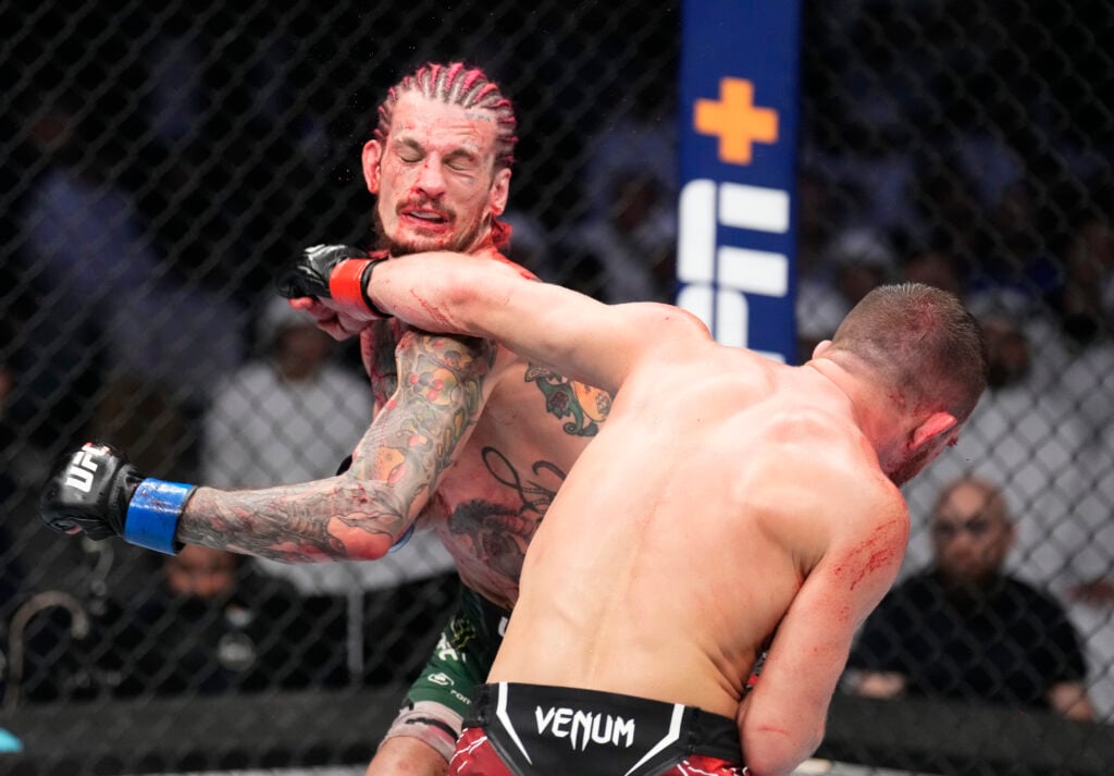 Petr Yan lands a left hand on Sean O'Malley during UFC 280 fight