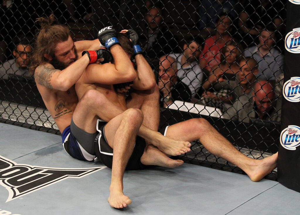 Michael Chiesa grapples with Al Iaquinta during their fight on The Ultimate Fighter 15 Finale
