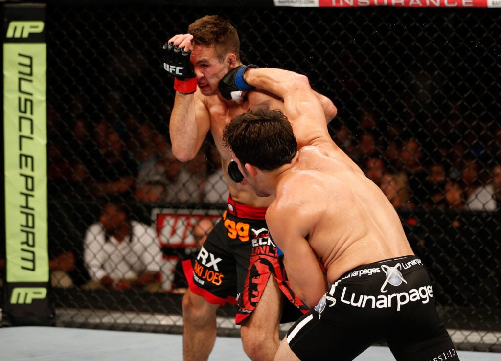 Jake Ellenberger lands a right hand on Rory MacDonald during UFC fight