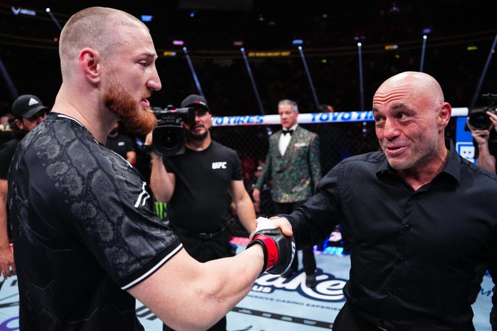 Joe Pyfer shakes hands with Joe Rogan after a knockout win at UFC 303