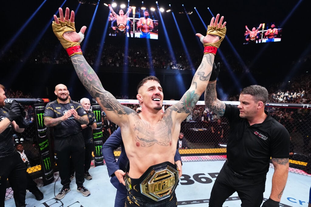 Tom Aspinall celebrates with his UFC title belt