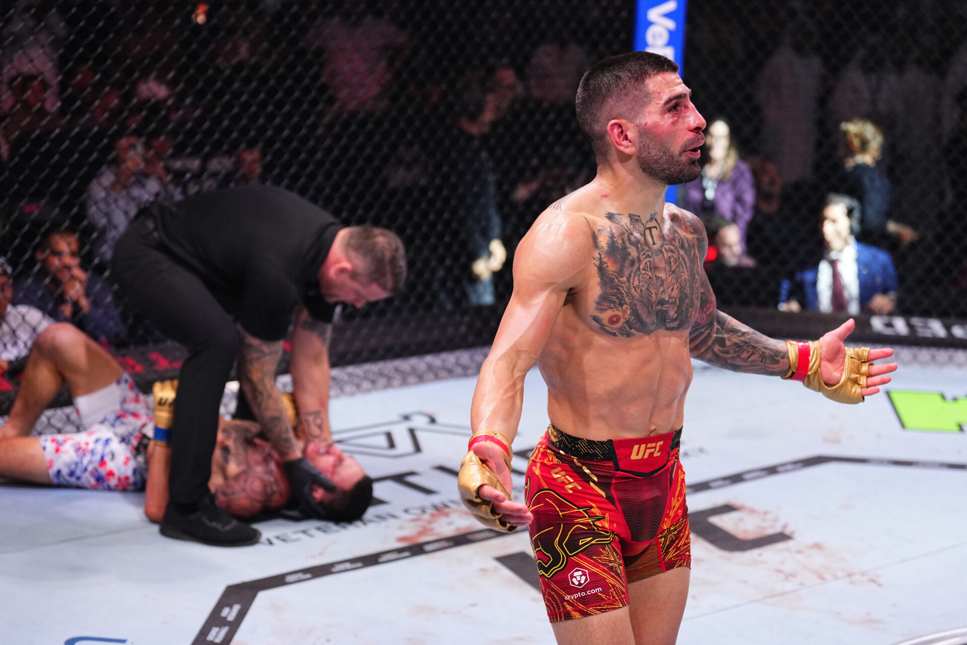 Ilia Topuria celebrates after beating Max Holloway at UFC 308
