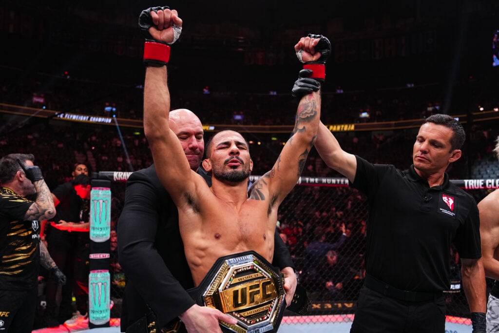 Alexandre Pantoja celebrating in the octagon after his fight at UFC 310