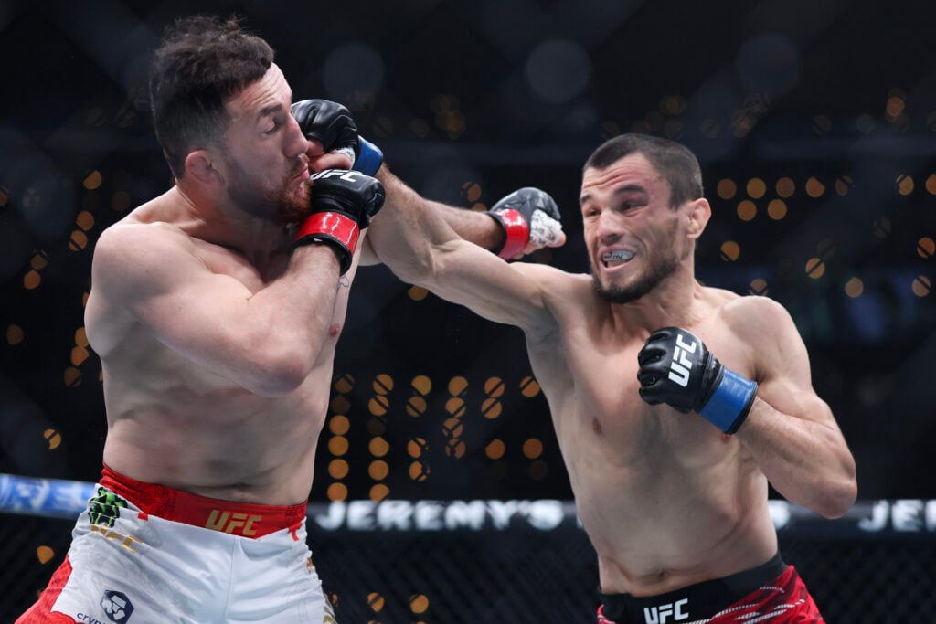 Image of Umar Nurmagomedov punching Merab Dvalishvili at UFC 311
