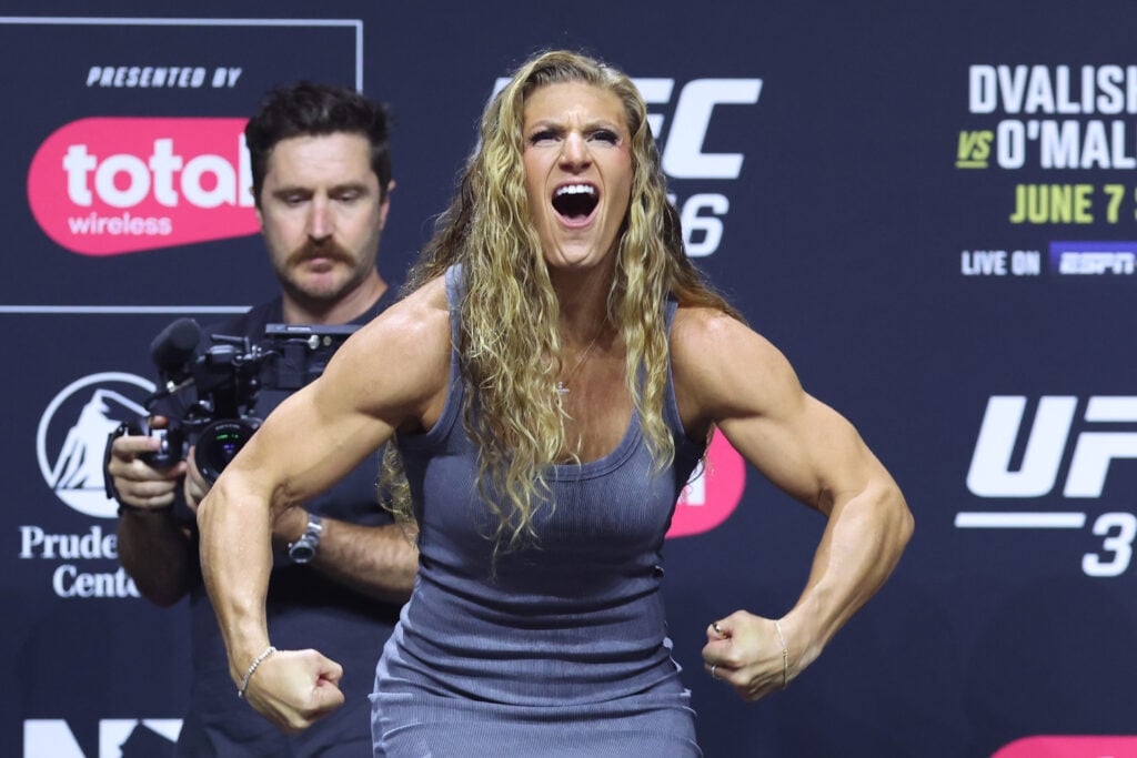 Kayla Harrison poses on stage at the UFC 316 Press Conference